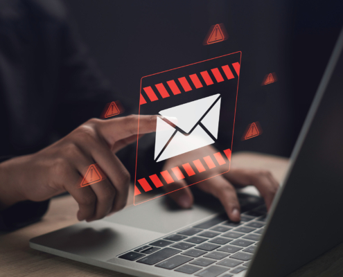 Side view of a man pressing a holographic email button hovering over his laptop